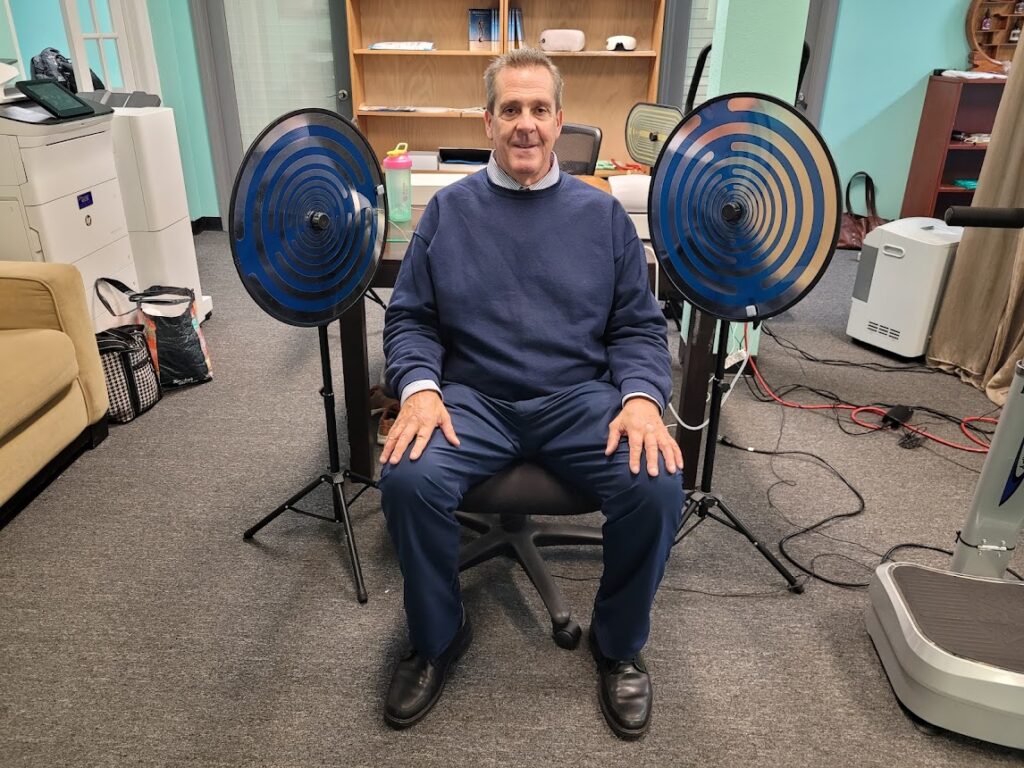 Sean Callahan aka "Mr. Hospital Beds" sitting in a set of Tesla Multi Wave Oscillators